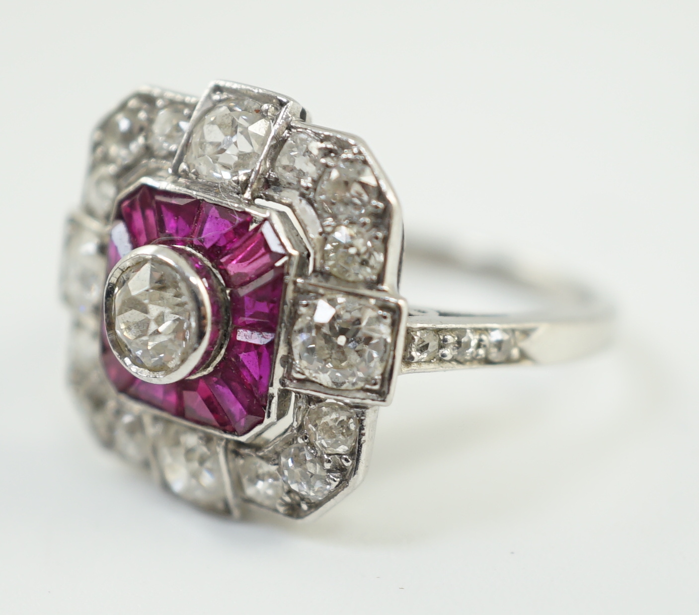 A 1920's/1930's platinum, ruby and diamond cluster set dress ring